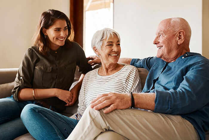 senior man smiling at home with family