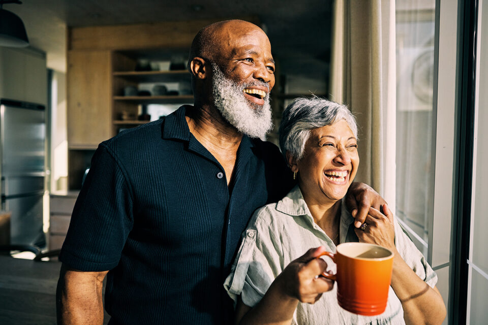 smiling mature couple looking out the window